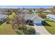 House with tile roof, driveway, and green lawn in a residential neighborhood at 218 Brandywine Circle, Englewood, FL 34223
