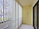 Screened porch with tiled floors and vertical blinds offering privacy at 5400 34Th W St # 3D, Bradenton, FL 34210