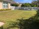 Large backyard with grassy area and fence at 5715 71St E St, Palmetto, FL 34221