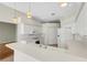 White kitchen with stainless steel appliances and a breakfast bar at 4193 Westbourne Cir, Sarasota, FL 34238