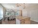 Kitchen with island, granite countertops, and view into Gathering room at 16914 Myrtle Hill Ln, Parrish, FL 34219