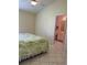 Main bedroom with tile floors and an ensuite bathroom at 4909 70Th E St, Palmetto, FL 34221