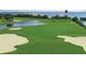 Elevated view of a scenic golf course with sand traps and a pond at 5941 Gulf Of Mexico Dr, Longboat Key, FL 34228