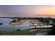 Aerial view of a marina at sunset, showcasing numerous boats and calm waters at 5941 Gulf Of Mexico Dr, Longboat Key, FL 34228