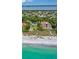 Aerial view of a beachfront property with a large house and expansive ocean views at 5941 Gulf Of Mexico Dr, Longboat Key, FL 34228