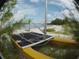 Yellow catamaran on the beach, partially obscured by vegetation at 5941 Gulf Of Mexico Dr, Longboat Key, FL 34228