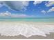 Picturesque beach scene with calm waves lapping the shore at 5941 Gulf Of Mexico Dr, Longboat Key, FL 34228