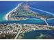 Aerial view of coastal community with beachfront homes and golf course at 5941 Gulf Of Mexico Dr, Longboat Key, FL 34228