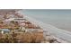 Aerial view of a coastal community featuring beach, homes, and lush vegetation at 5941 Gulf Of Mexico Dr, Longboat Key, FL 34228