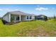 Landscaped backyard with a covered patio and a screened-in pool enclosure at 10442 Morning Mist, Sarasota, FL 34241
