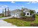 New construction home with manicured landscaping, a paved driveway, and a three-car garage at 10442 Morning Mist, Sarasota, FL 34241