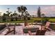 Cozy outdoor fire pit with Adirondack chairs, ideal for evening gatherings and enjoying the serene surroundings at 10442 Morning Mist, Sarasota, FL 34241