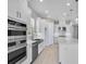 Modern kitchen with stainless steel appliances, double ovens and white cabinetry at 10442 Morning Mist, Sarasota, FL 34241