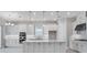 Modern kitchen with stainless steel appliances, white cabinets and a central island at 10442 Morning Mist, Sarasota, FL 34241