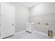 Laundry room featuring tile floors, wire shelving, a sink and cabinet at 10442 Morning Mist, Sarasota, FL 34241