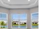 Bright living room with large windows offering scenic water views at 10442 Morning Mist, Sarasota, FL 34241