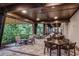 Covered outdoor patio area with comfortable seating and lush greenery, perfect for relaxing and socializing at 10442 Morning Mist, Sarasota, FL 34241
