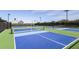 Modern pickleball courts with blue and green surfaces, offering an active community amenity at 10442 Morning Mist, Sarasota, FL 34241