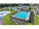 Aerial view of sparkling swimming pool with lap lanes, surrounded by lounge chairs and lush landscaping at 10442 Morning Mist, Sarasota, FL 34241