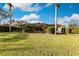 Large backyard with a screened patio and mature landscaping at 22575 Morning Glory Cir, Bradenton, FL 34202