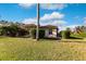 Backyard view showing home's exterior and surrounding landscape at 22575 Morning Glory Cir, Bradenton, FL 34202