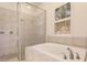 Bathroom with a shower and bathtub, and a window with blinds at 22575 Morning Glory Cir, Bradenton, FL 34202
