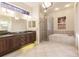 Elegant bathroom with double sinks, soaking tub, and separate shower at 22575 Morning Glory Cir, Bradenton, FL 34202