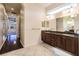 Bathroom boasts double vanity, granite countertop, and hardwood floors at 22575 Morning Glory Cir, Bradenton, FL 34202