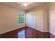 Bedroom with hardwood floors, large closet, and window at 22575 Morning Glory Cir, Bradenton, FL 34202