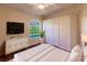 Bright bedroom with wood floors, large window, and ample closet space at 22575 Morning Glory Cir, Bradenton, FL 34202