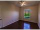 Empty bedroom featuring hardwood floors and a window with a backyard view at 22575 Morning Glory Cir, Bradenton, FL 34202