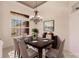 Formal dining room featuring a dark wood table, chandelier, and neutral decor at 22575 Morning Glory Cir, Bradenton, FL 34202