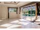 Gathering room with sliding doors opening to the pool and screened patio at 22575 Morning Glory Cir, Bradenton, FL 34202