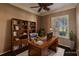 Home office with built-in shelving and hardwood floors at 22575 Morning Glory Cir, Bradenton, FL 34202