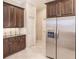 Modern kitchen with dark wood cabinets, granite countertops and stainless steel appliances at 22575 Morning Glory Cir, Bradenton, FL 34202