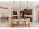 Modern kitchen with dark wood cabinets, granite countertops, stainless steel appliances, and breakfast bar at 22575 Morning Glory Cir, Bradenton, FL 34202