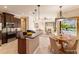 Open kitchen with island, stainless steel appliances, and views of the Gathering room and pool at 22575 Morning Glory Cir, Bradenton, FL 34202