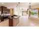 Open kitchen with island, stainless steel appliances, and views of the Gathering room and pool at 22575 Morning Glory Cir, Bradenton, FL 34202