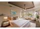 Virtually staged main bedroom with ensuite bathroom access at 22575 Morning Glory Cir, Bradenton, FL 34202