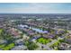 Expansive aerial view of a Primary-planned community featuring pristine lakes and well-maintained landscaping at 2921 Seasons Blvd, Sarasota, FL 34240