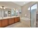 Bright bathroom features double vanity, soaking tub, and glass enclosed shower at 2921 Seasons Blvd, Sarasota, FL 34240