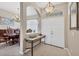 Welcoming foyer features tile flooring, arched doorway, and a decorative table, adjacent to the dining room at 2921 Seasons Blvd, Sarasota, FL 34240