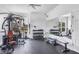 Bright fitness center featuring weightlifting equipment, a mirrored wall, and a ceiling fan for comfortable workouts at 2921 Seasons Blvd, Sarasota, FL 34240