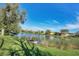 Picturesque lake view with lush greenery and waterfront houses at 2921 Seasons Blvd, Sarasota, FL 34240