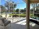 Covered lanai with comfortable seating and serene water views at 2921 Seasons Blvd, Sarasota, FL 34240