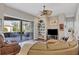 Bright living area with sliding glass doors to the lanai, built-in shelving, and a plush leather sectional at 2921 Seasons Blvd, Sarasota, FL 34240