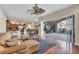 Open living space with a leather sectional, a ceiling fan, and a seamless transition to the outdoor patio at 2921 Seasons Blvd, Sarasota, FL 34240