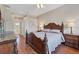 Elegant main bedroom features hardwood floors, a decorative headboard, and ample natural light from large windows at 2921 Seasons Blvd, Sarasota, FL 34240