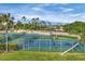 Well-maintained community tennis courts surrounded by lush landscaping at 2921 Seasons Blvd, Sarasota, FL 34240
