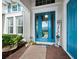 Inviting front entrance with a bright blue door and welcoming decor at 5130 Tidewater Preserve Blvd, Bradenton, FL 34208